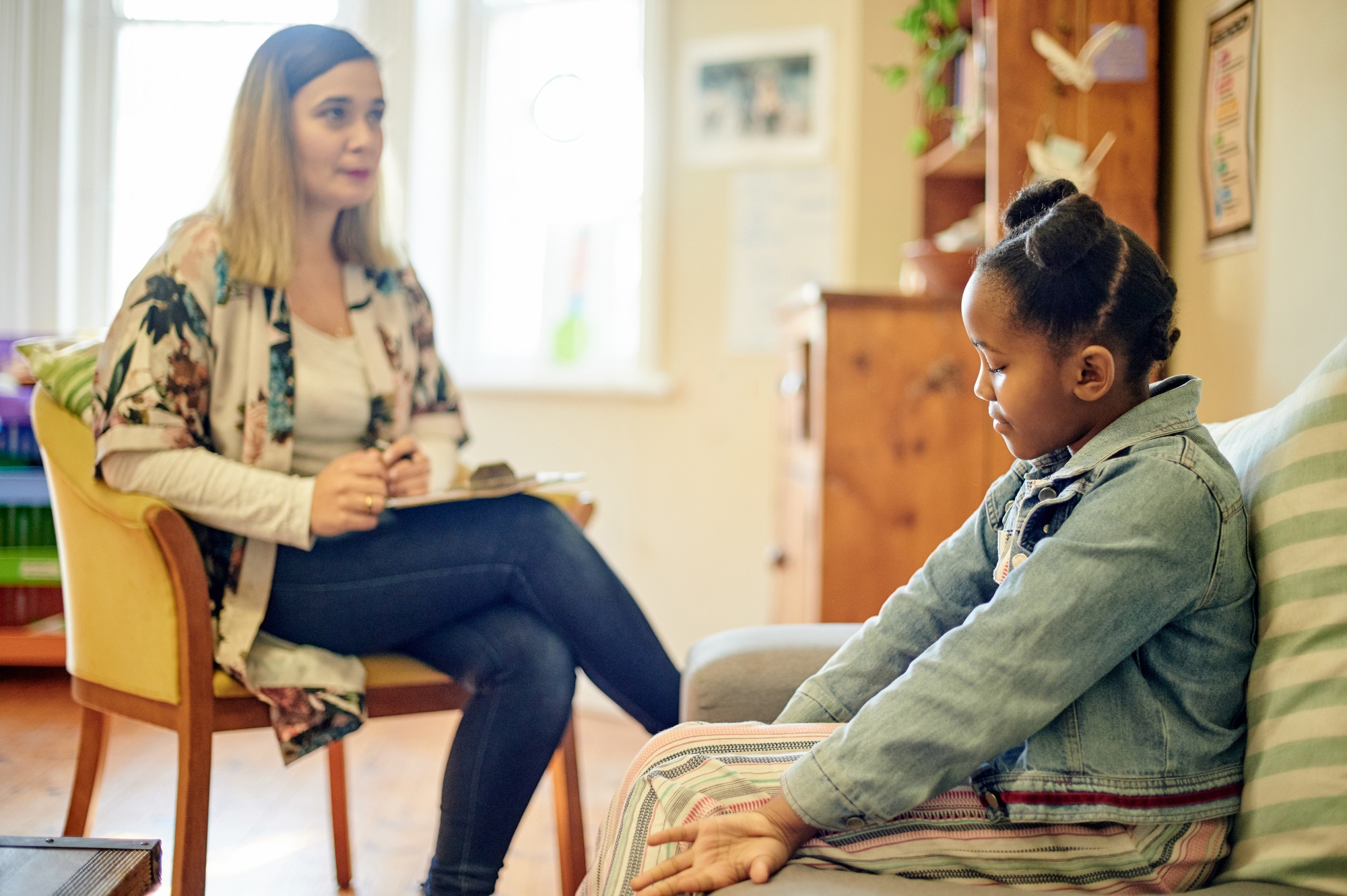 Psychologist, black kid and consultation in office for depression, anxiety or mental health. Psycho